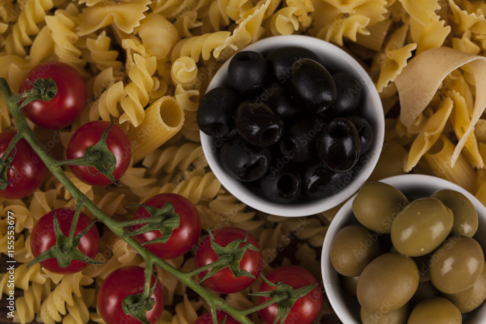 Dry pasta with ingredients on a old wood Dry pasta with ingredients on a old wood