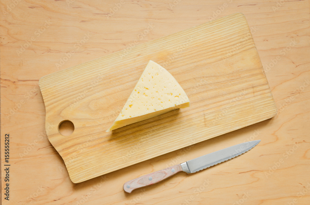 Cheese is on a kitchen board