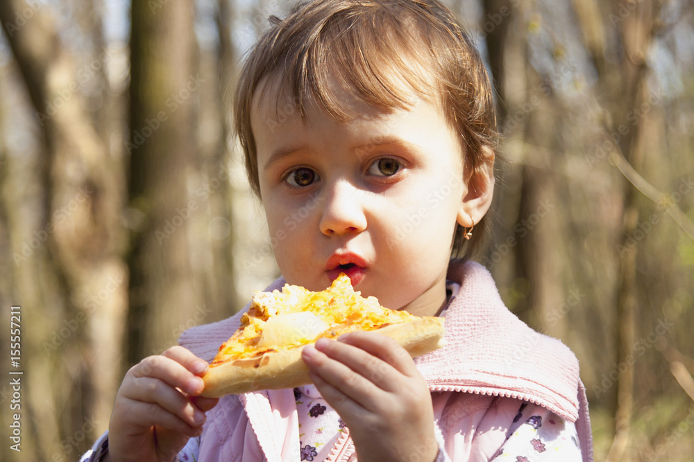 Beautiful little girl enjoying a delicious pizza (food, hunger, pleasure) Beautiful little girl enjoying a delicious pizza (food, hunger, pleasure)