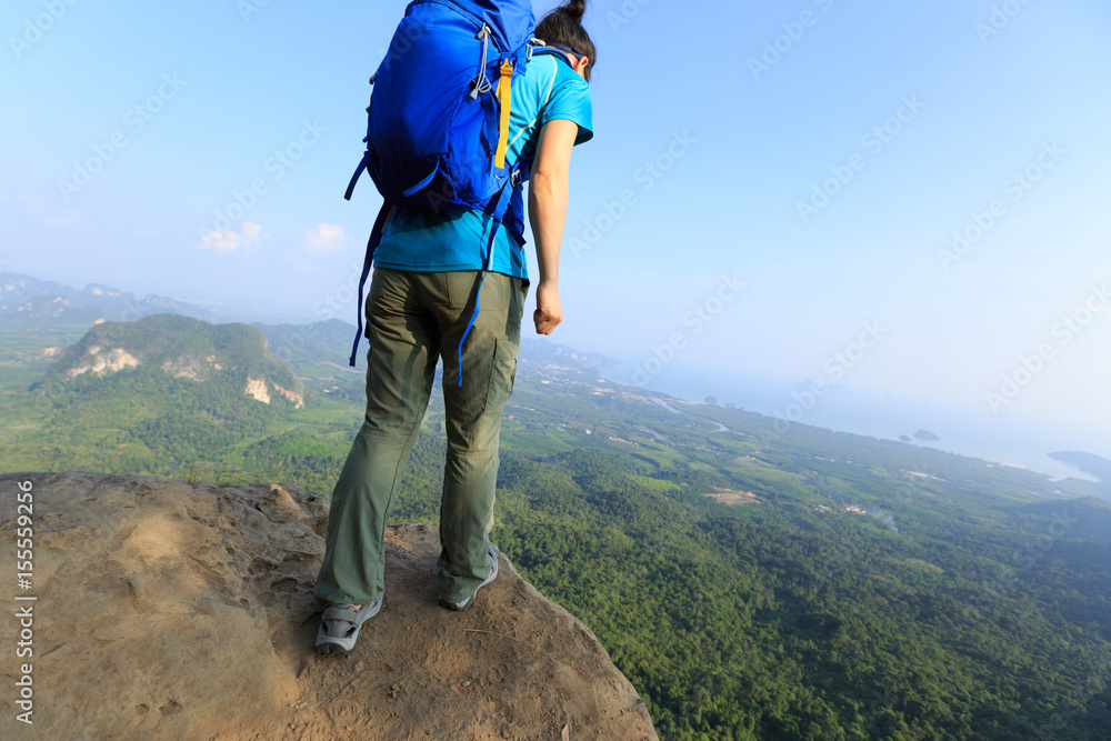 Obraz premium successful woman hiker enjoy the view hiking on mountain peak