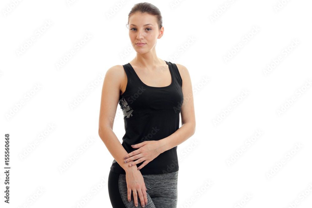 charming young slender girl in grey sports suit looks into the camera and stands charming young slender girl in grey sports suit looks into the camera and stands