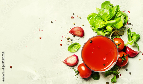 Tomato juice with green basil and spices, top view, food background © 5ph