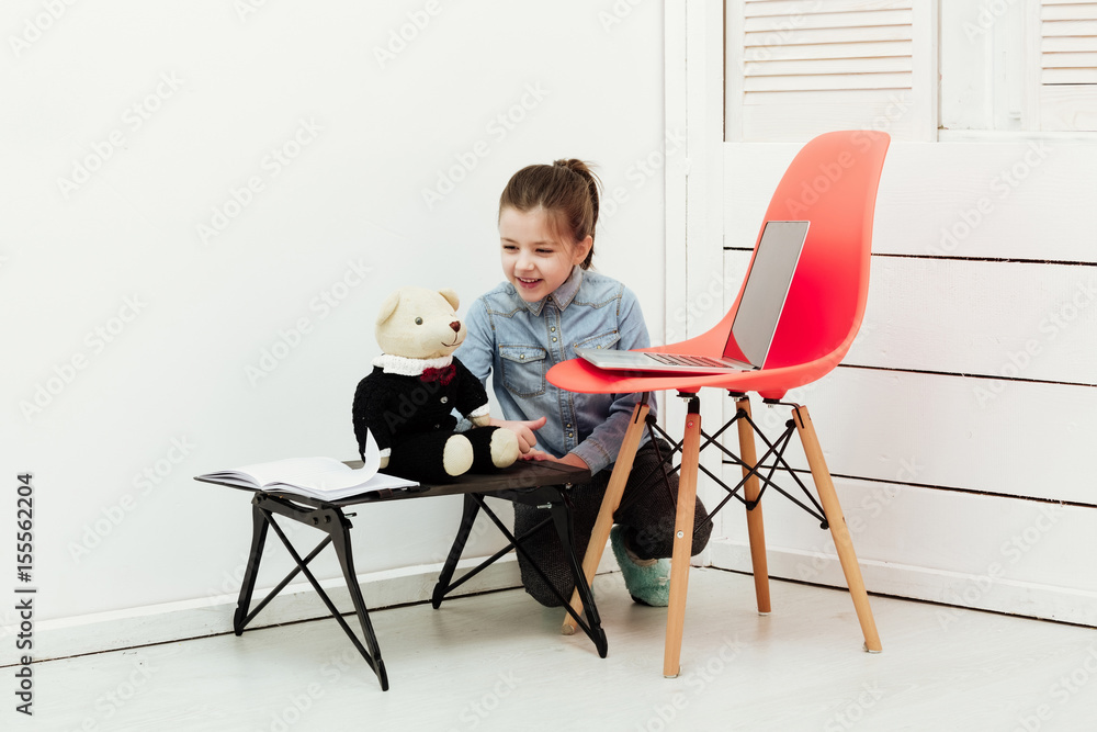 Fototapeta premium Happy pretty girl smiling to teddy bear toy