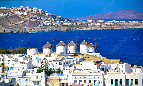 Two of the famous windmills in Mykonos, Greece during a clear and bright summer sunny day photo