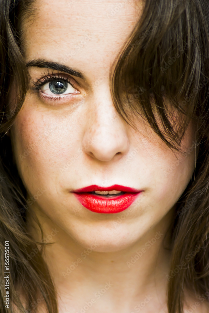 Portrait of a beautiful woman with her hair covering her eye Portrait of a beautiful woman with her hair covering her eye