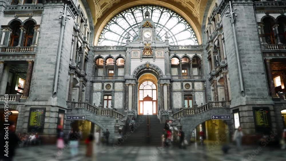 Anwerpen (Antwerp) railroad station building interior hall with passengers. Famous historical landmark in Belgium. Time-lapse Anwerpen (Antwerp) railroad station building interior hall with passengers. Famous historical landmark in Belgium. Time-lapse