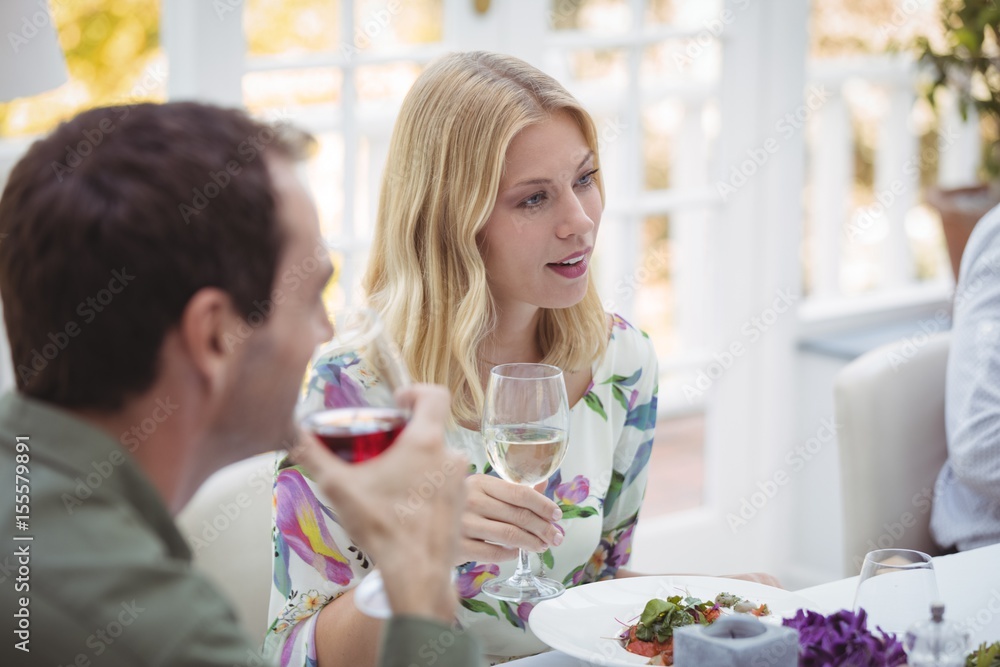 Smiling woman having wine during lunch Smiling woman having wine during lunch
