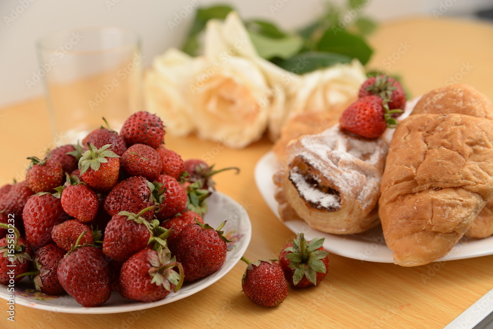 Delicious breakfast with fresh pastry and strawberries Delicious breakfast with fresh pastry and strawberries