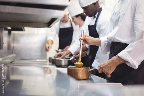 Team of chef preparing food in the commercial kitchen