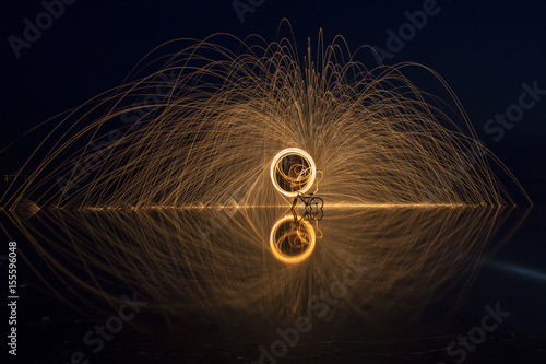 Sparks Flying off Burning Steel Wool. Burning steel wool fireworks water reflection 