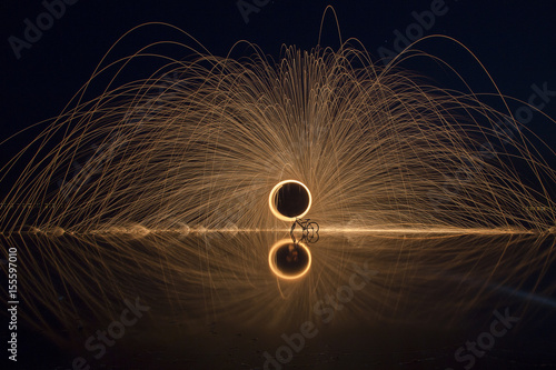 Sparks Flying off Burning Steel Wool. Burning steel wool fireworks water reflection 