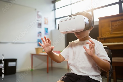 Happy boy wearing virtual reality simulator 