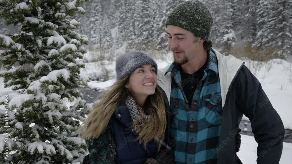 Fun Couple Pose For Portrait, Then Kiss, Then Woman Pushes Her Boyfriend, He Falls In Snow, Then He Throws Snow At Her Fun Couple Pose For Portrait, Then Kiss, Then Woman Pushes Her Boyfriend, He Falls In Snow, Then He Throws Snow At Her