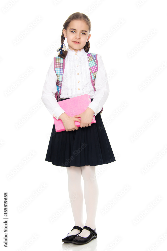 The girl is a schoolgirl with a book in her hands.