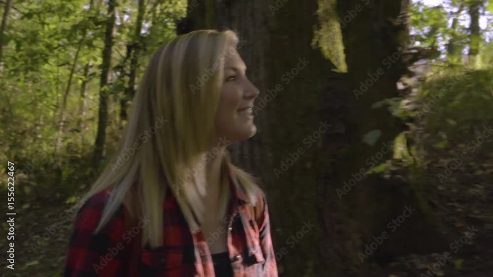 Young Woman Walks (Toward Camera) Along Trail On Sunny Day In Pacific Northwest Young Woman Walks (Toward Camera) Along Trail On Sunny Day In Pacific Northwest