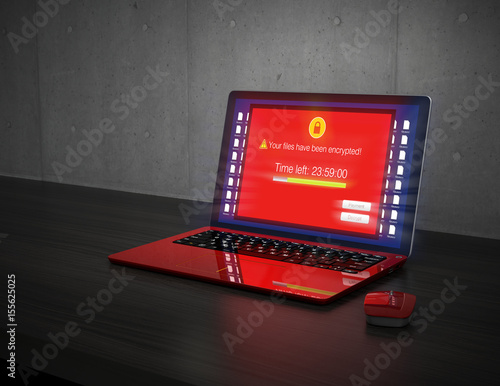 Фотография Screen of laptop computer showing alert that the computer was attacked by ransomware