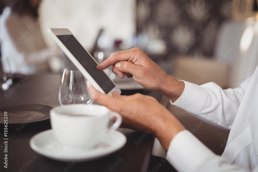 Mid section of woman using digital tablet Mid section of woman using digital tablet
