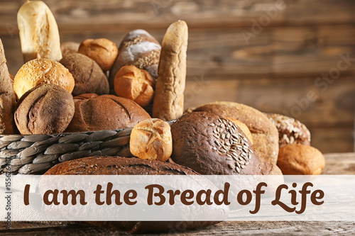 Many different types of fresh bread on old wooden table