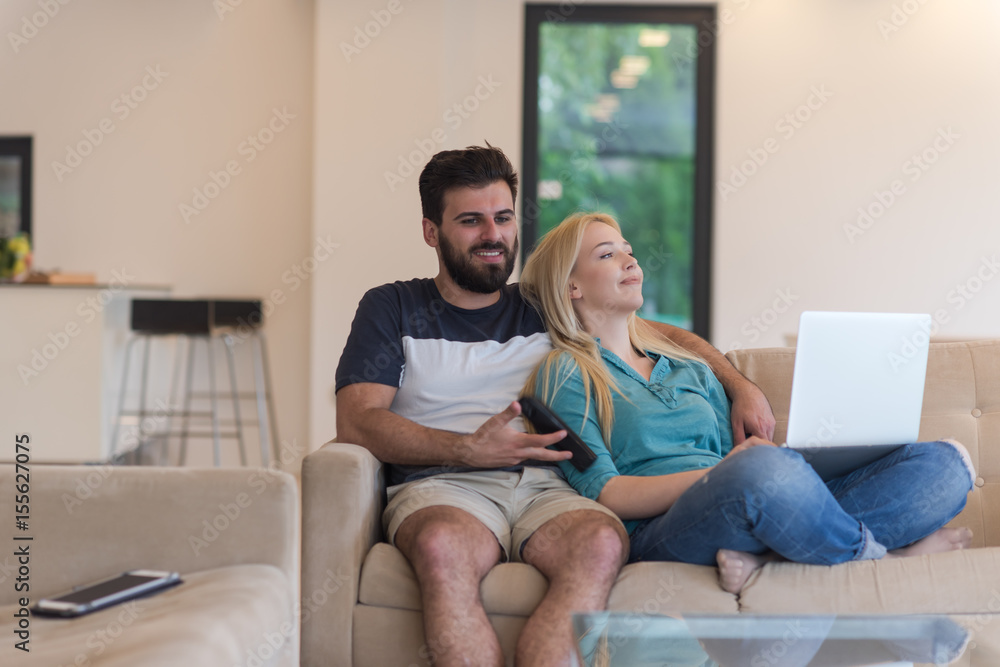 young happy couple relaxes in the living room