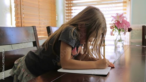 Pretty little girl writing