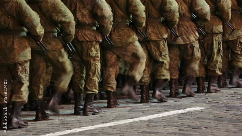 Formation of soldiers marching to the place in the night on the pavement Formation of soldiers marching to the place in the night on the pavement