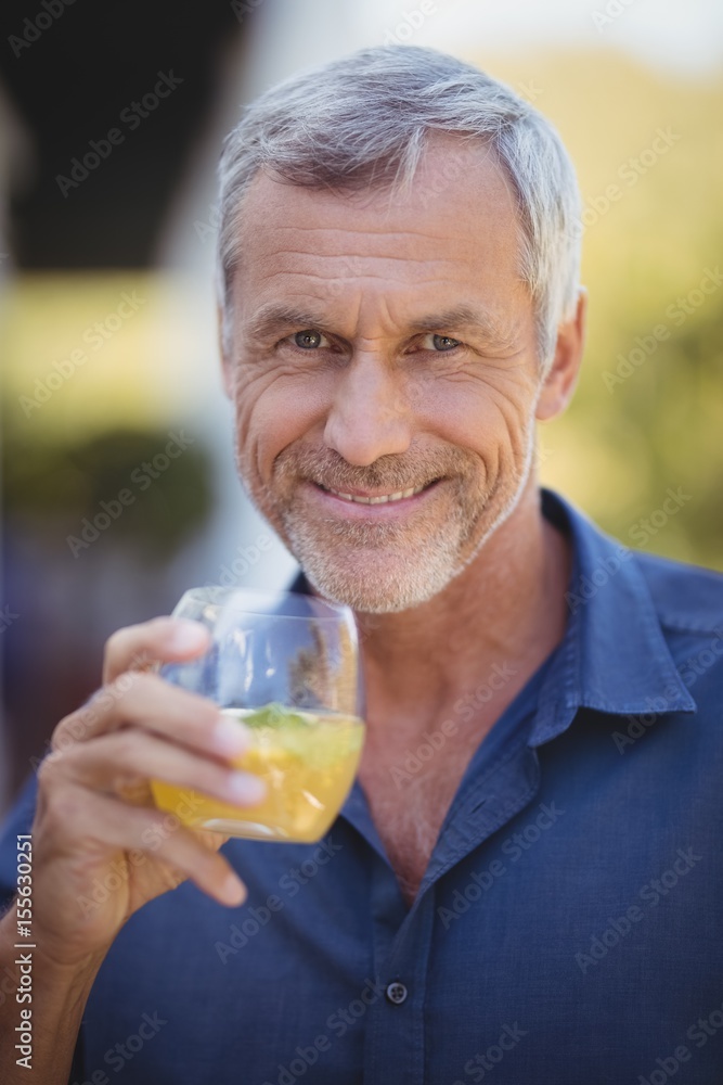 Portrait of mature man having a glass of juice