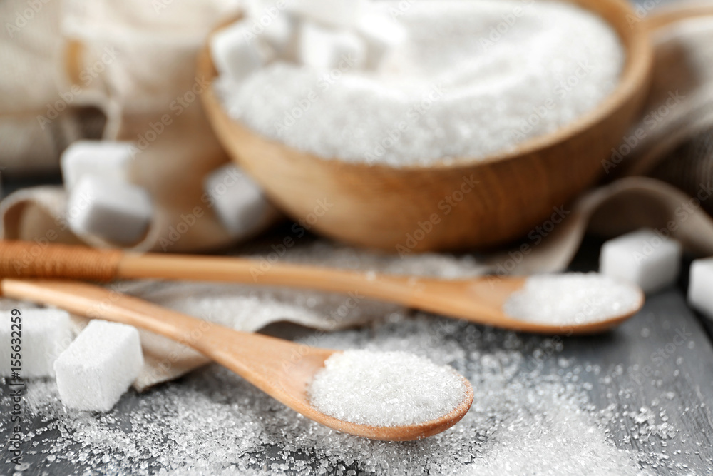 Bowl and spoons with sugar on wooden table, closeup Bowl and spoons with sugar on wooden table, closeup