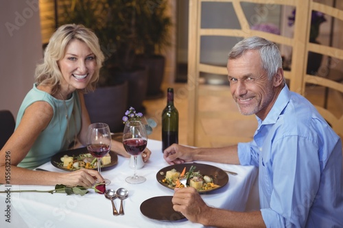 Portrait of mature couple having dinner and red wine
