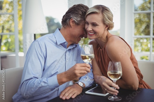 Couple interacting while having wine in restaurant © wavebreak3