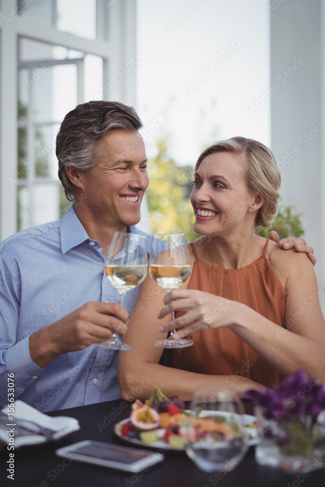 Couple toasting glasses of wine in restaurant Couple toasting glasses of wine in restaurant