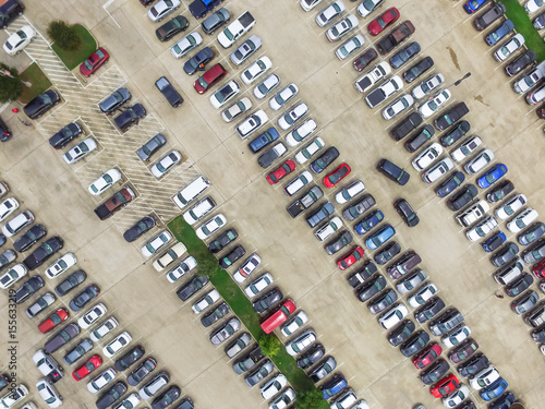 Aerial view full cars at large outdoor parking lots in Houston  Texas  USA. Outlet mall parking congestion and crowded parking lot with other cars try getting in and out  finding parking space.