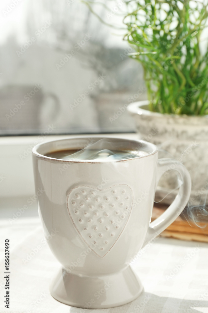 Cup of delicious coffee on window sill Cup of delicious coffee on window sill