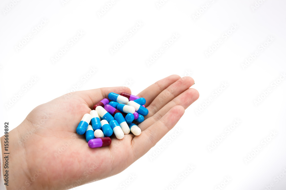 hand holding drug capsule on white background hand holding drug capsule on white background