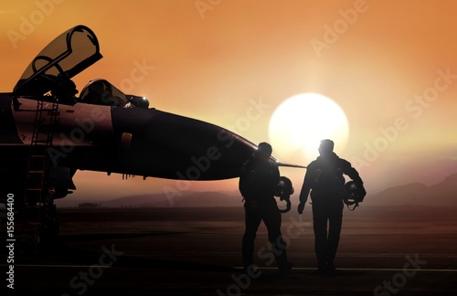 Fighter pilot and supersonic jet on military airbase during sunset