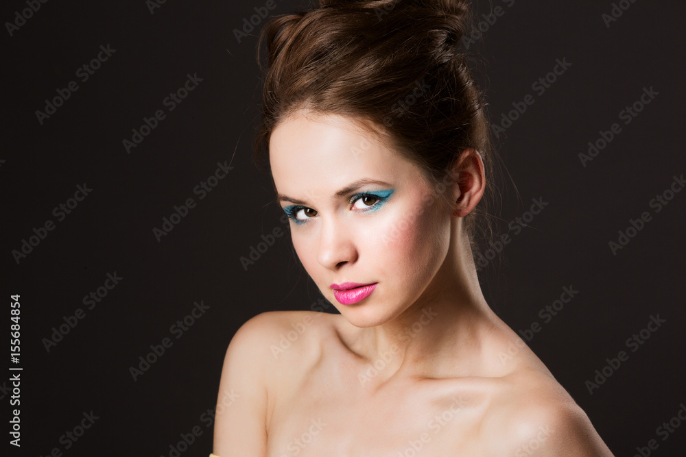 Portrait of a beautiful woman on a dark background. Portrait of a beautiful woman on a dark background.