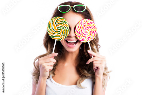 Portrait happy pretty smiling woman and lollipop isolated on white.
