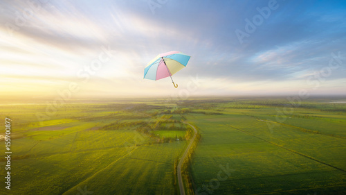 abstract umbrella flying with beautiful sky freedom background concept