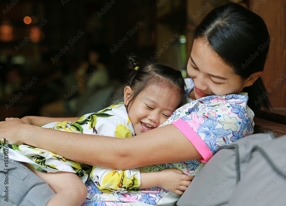 Obraz premium Happy loving family. mother hugging her child on sofa.
