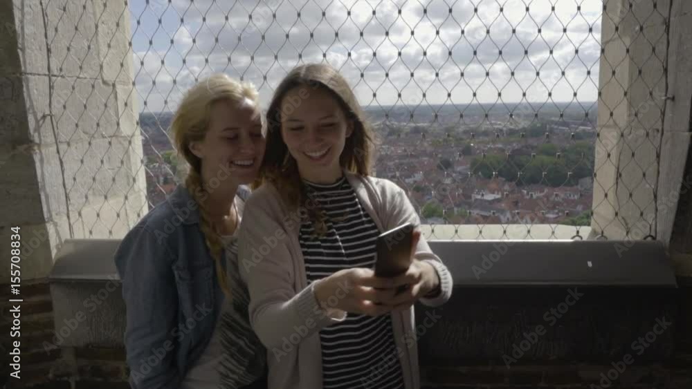 Travelers Take Fun Selfie Together At The Top Of The Belfry Of Bruges, A Medieval Bell Tower In Belgium Travelers Take Fun Selfie Together At The Top Of The Belfry Of Bruges, A Medieval Bell Tower In Belgium