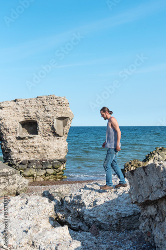 Young man in abandoned fortress ruins, Liepaja, Latvia.