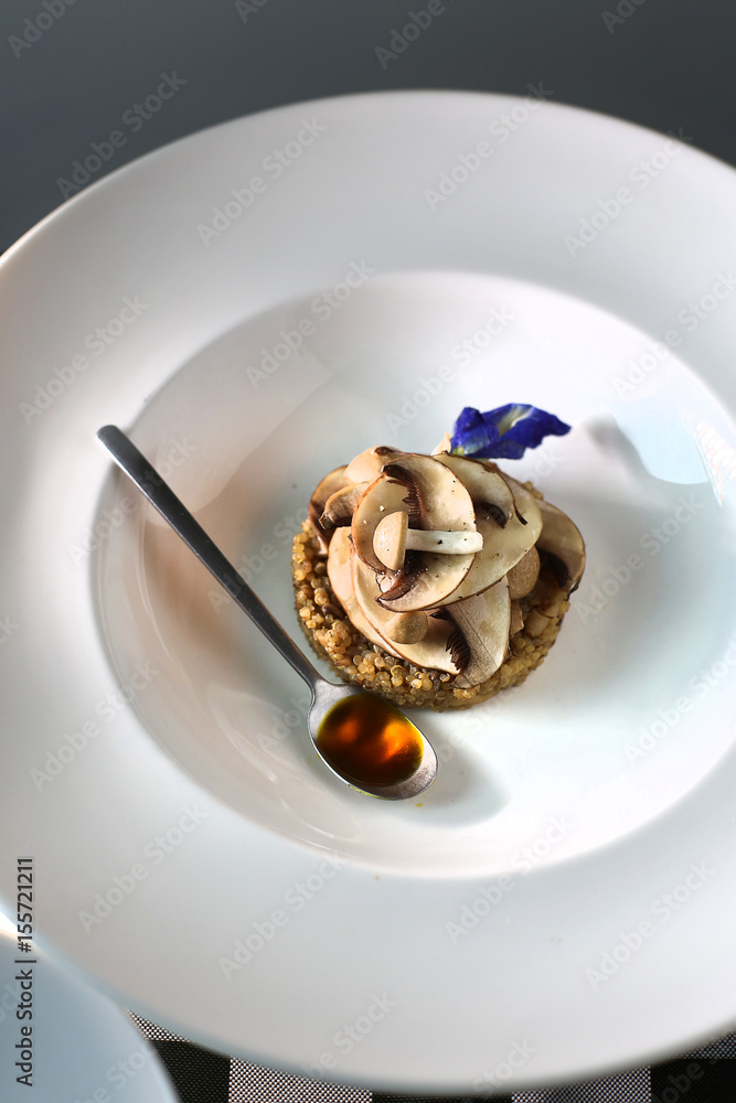 Ice cream desert in a white bowl and a spoon Ice cream desert in a white bowl and a spoon