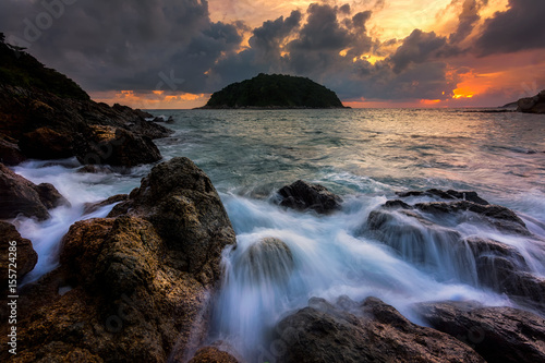 Seascape awesome wave on the rock with sunset and rain cloud at beach in phuket thailand