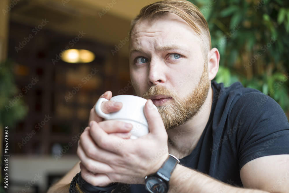 Young man drinking coffee on the street Young man drinking coffee on the street