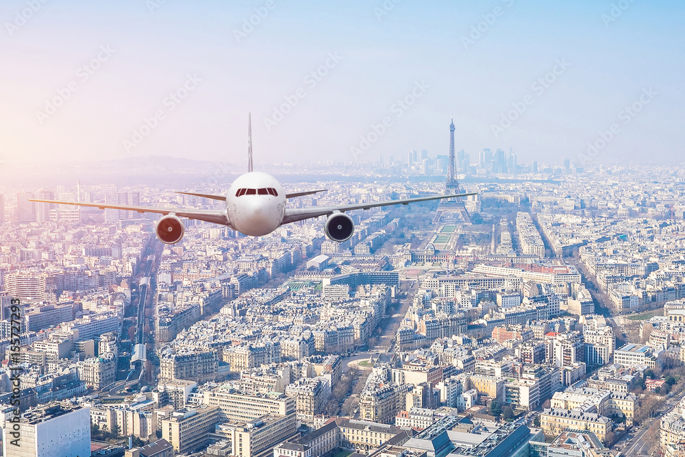 Fototapeta Airplane frying over the center of Paris, France