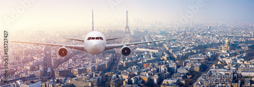 Airplane frying over the center of Paris, France © sahachat