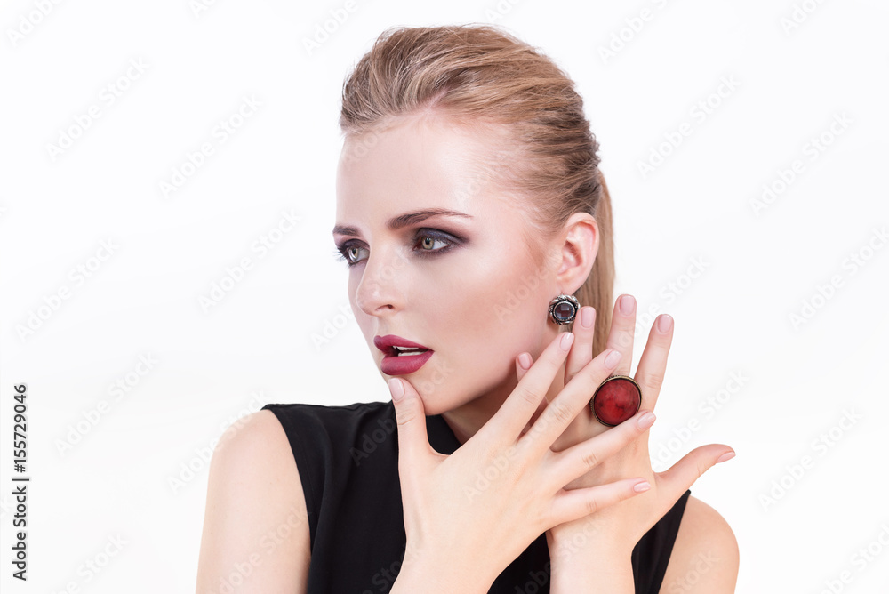 Beauty woman portrait. Beautiful model girl with perfect fresh clean skin and dark evening professional makeup wearing fashion jewelry. Blonde female showing ideal manicure Beauty woman portrait. Beautiful model girl with perfect fresh clean skin and dark evening professional makeup wearing fashion jewelry. Blonde female showing ideal manicure