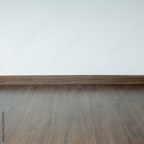 empty room interior, brown wood laminate floor and white mortar wall background © sutichak