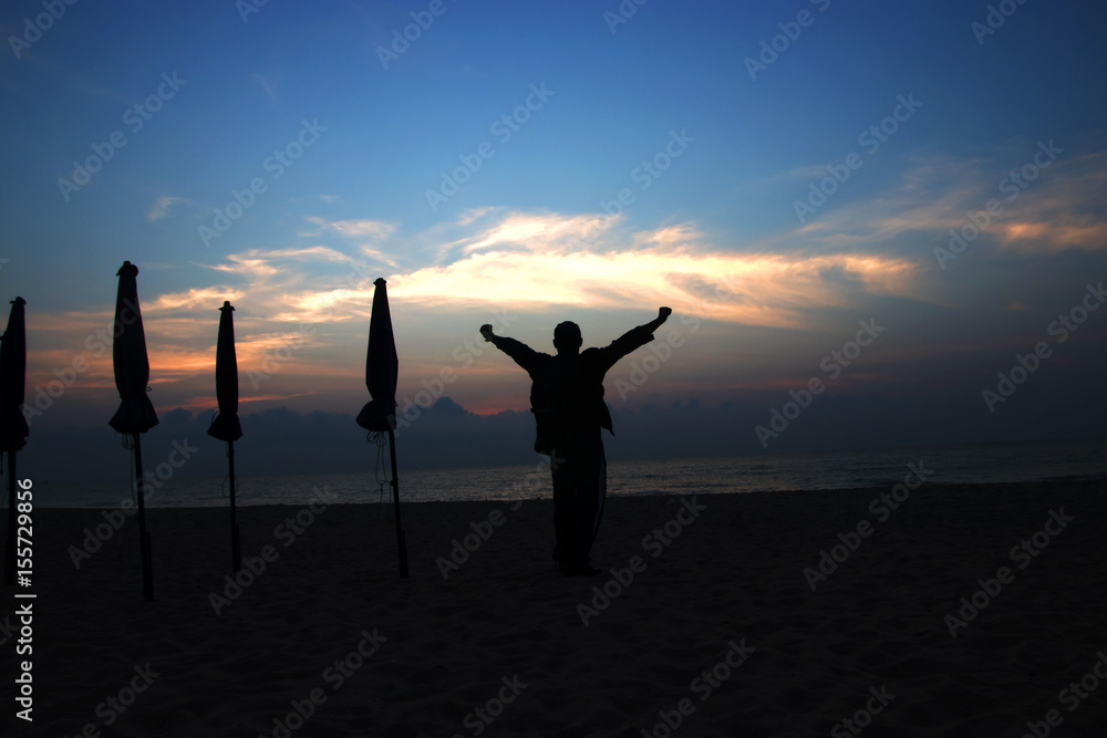 Fototapeta premium silhouettes on beach at sunrise