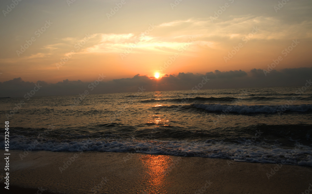 silhouettes on beach at sunrise