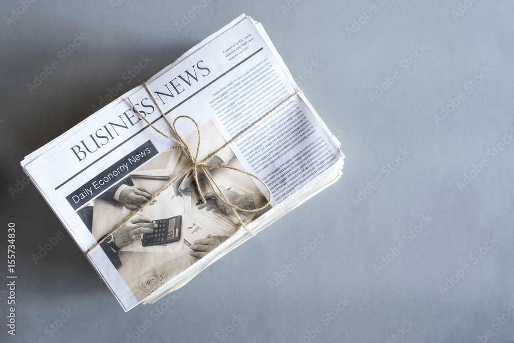 Stack of newspaper on wooden table Stack of newspaper on wooden table